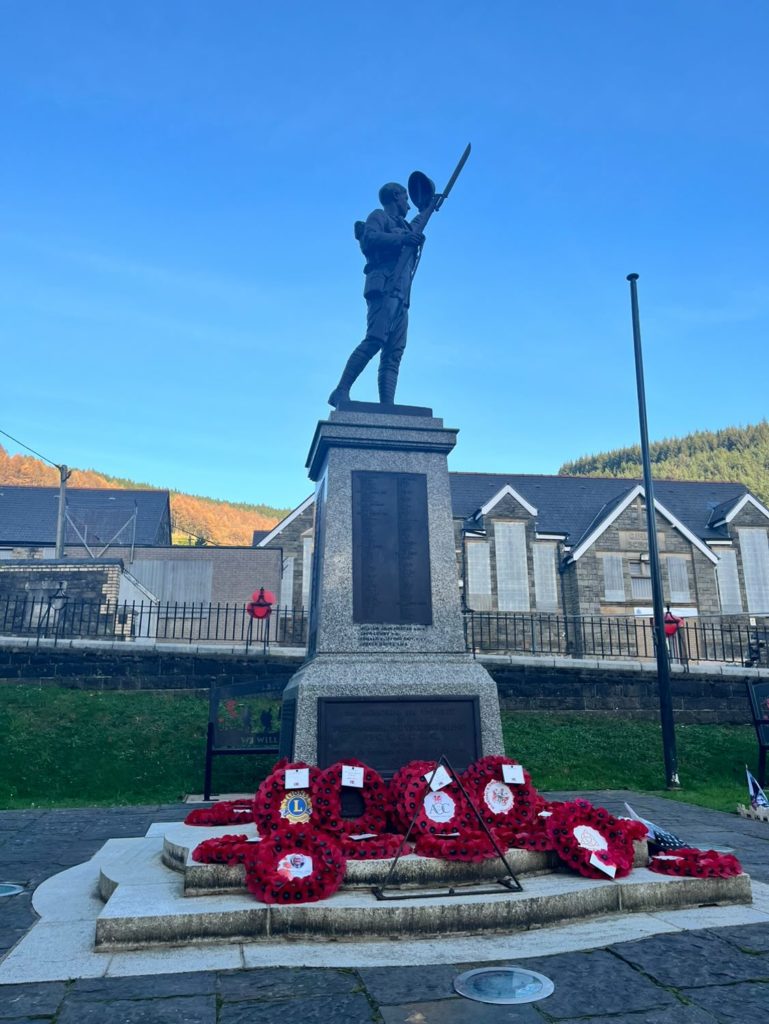 War memorial surrounded by poppy wreaths
